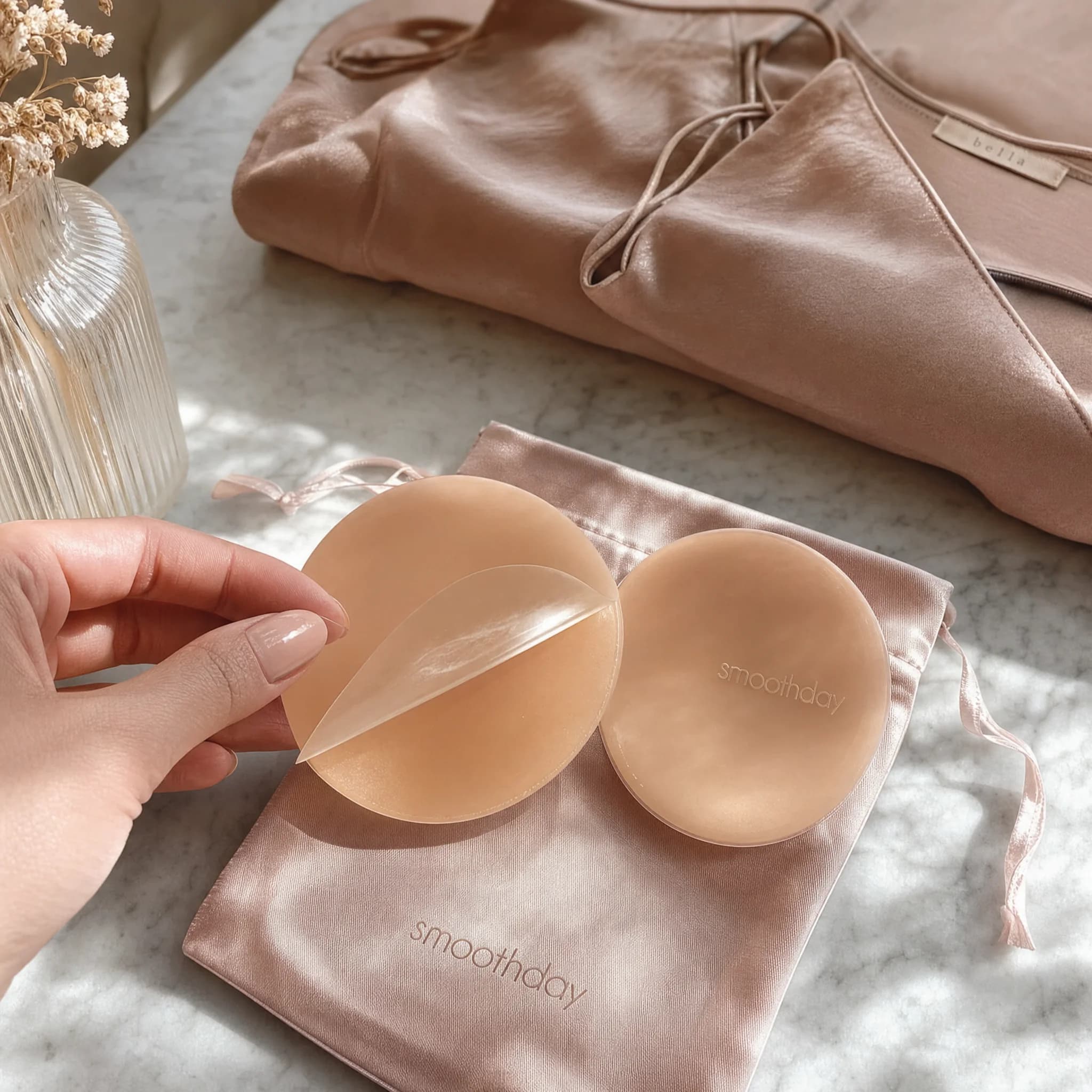 Reusable nipple cover with protective film being peeled